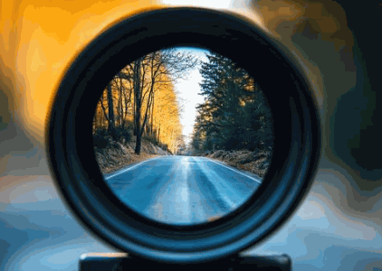 Looking down a road through a lens